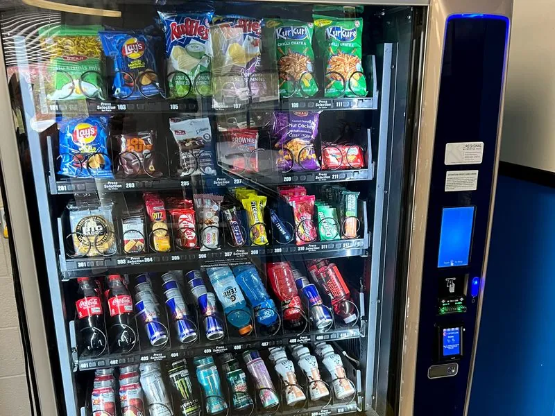 A stocked Regional Vending snack and drink machine with its card payment reader and touchscreen