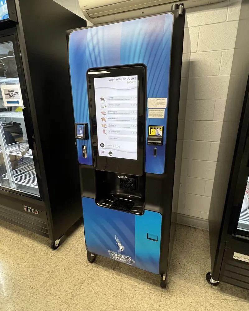 A customer paying by phone at a vending machine